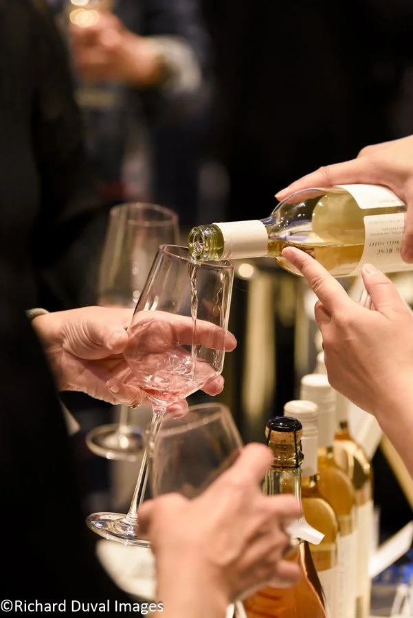 White wine being poured at a wine tasting