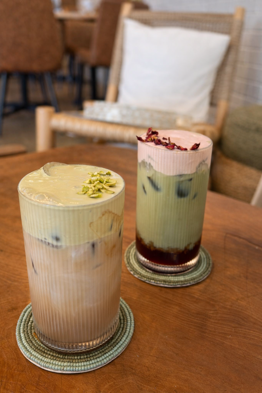 Layered iced drinks in cozy setting.png