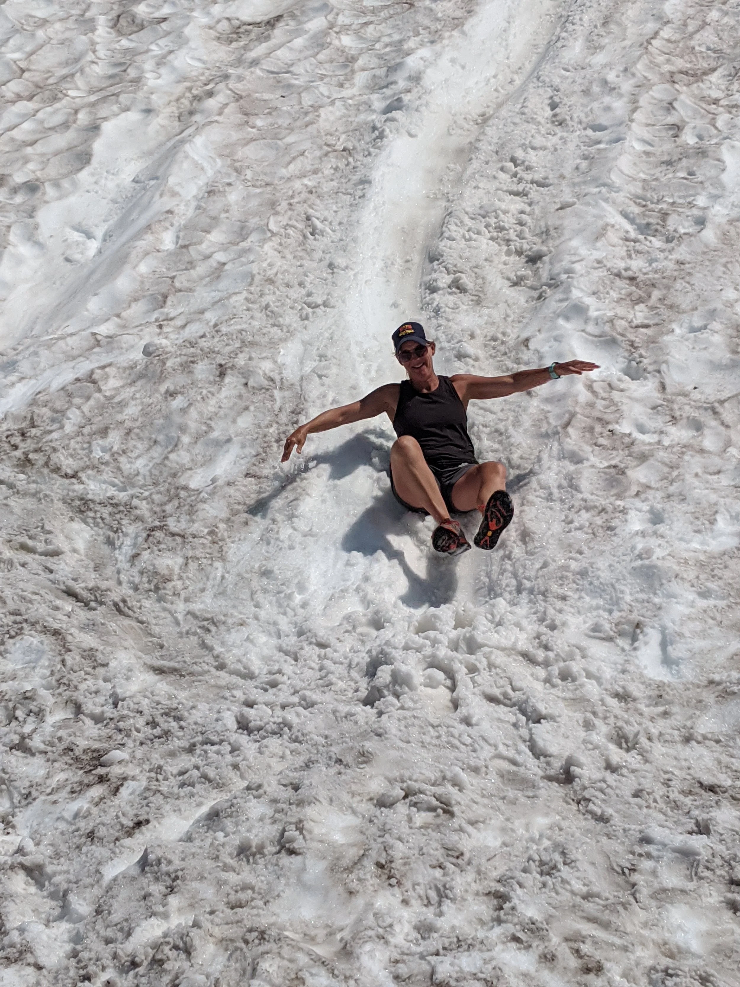 Katie sliding down a hill of snow