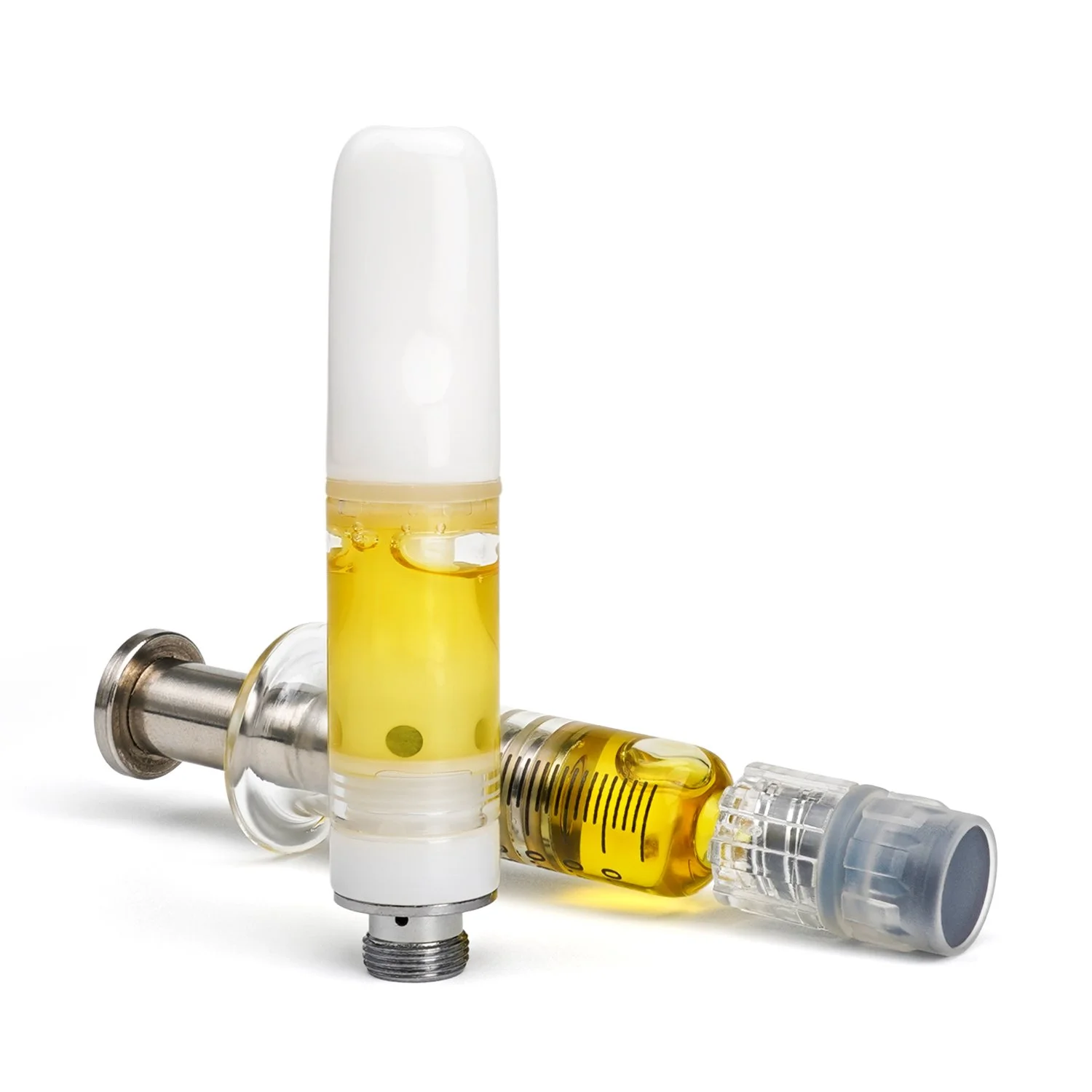 Cannabis extract cartridge and syringe dispenser together.