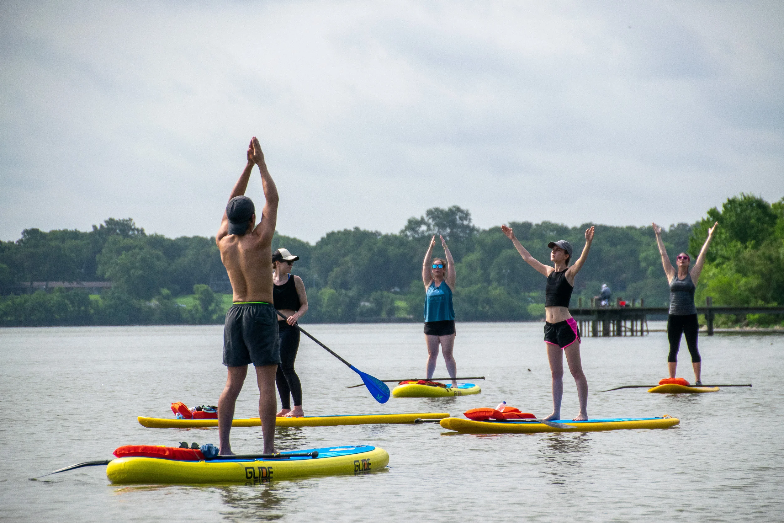 Yogis stretch on paddle boards at White Rock Lake in Dallas.