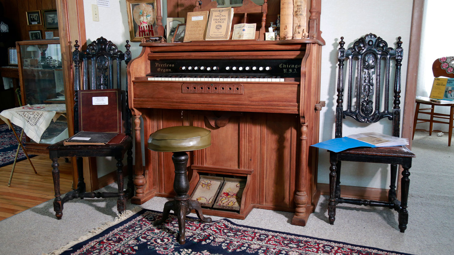 Antique organ with music books in the parlor of the Johanson House