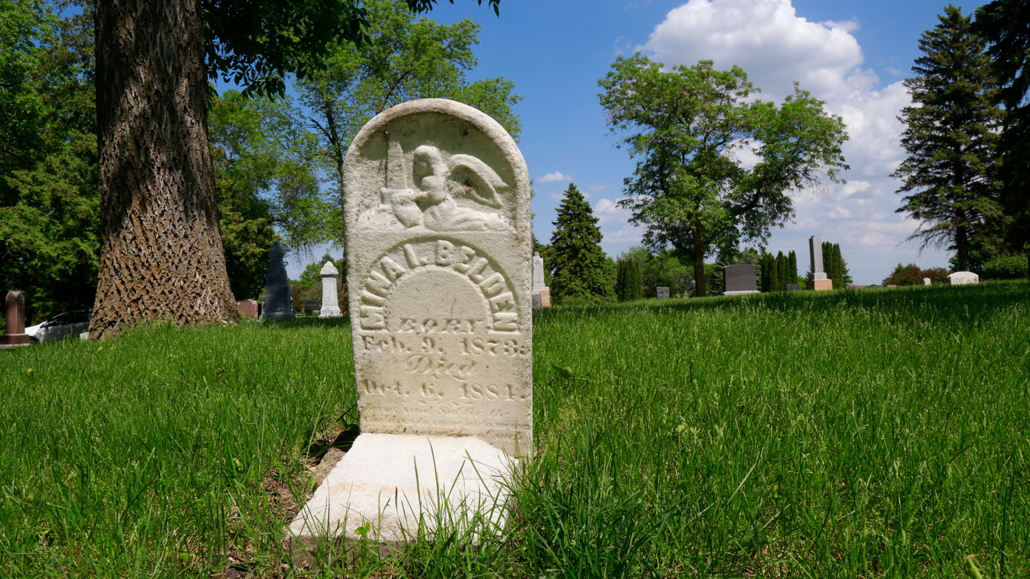 Ornately carved gravestone for a child dated 1884