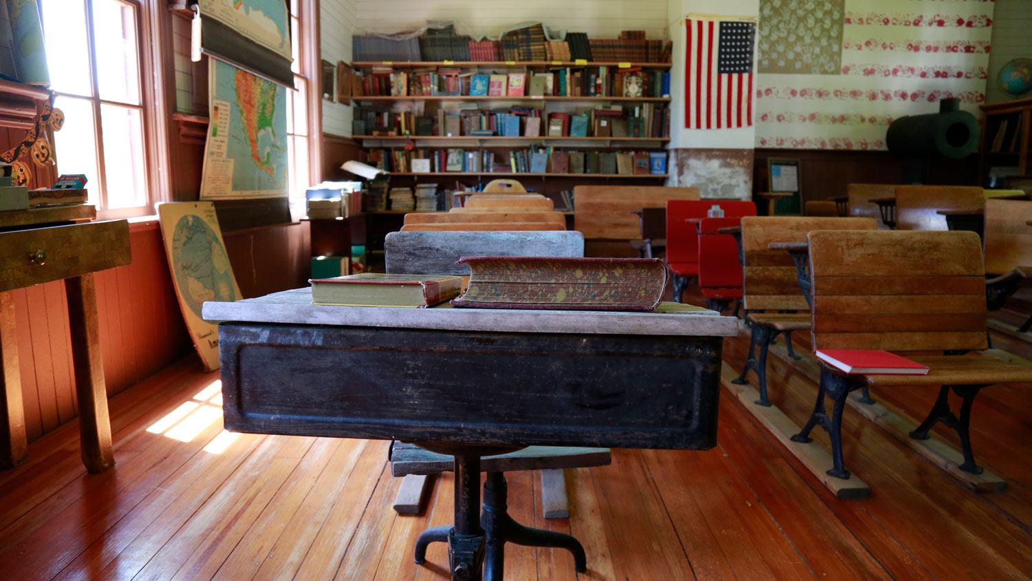A row of antique desks in the one room schoolhouse classroom in Pioneer Village