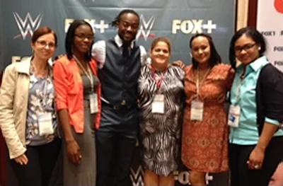 WWE pro wrestler Kofi Kingston poses with admirers at the CCTA Annual Meeting in Jamaica.