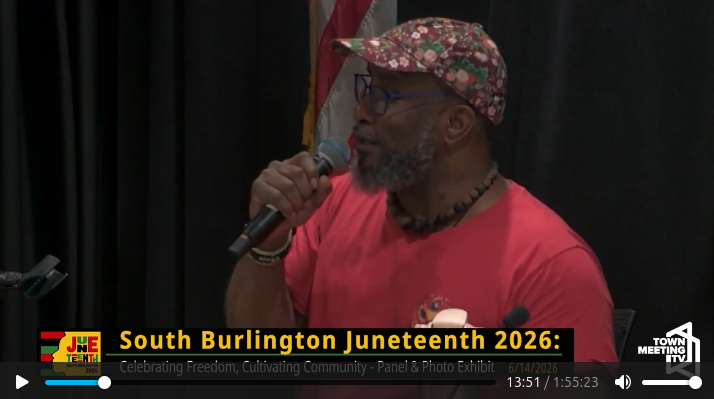 Rajnii Eddins holding a microphone, while speaking at South Burlington Juneteenth 2026