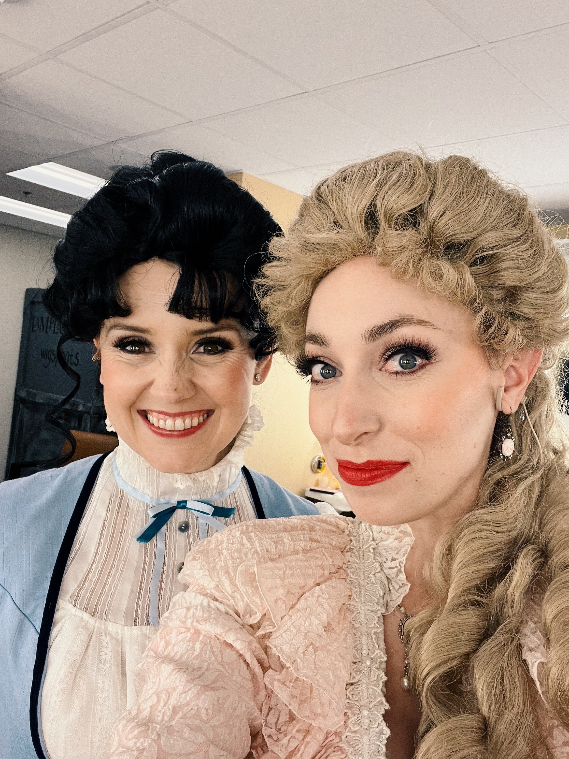  Leslie wearing pink dress and blond wig with castmate of  A Gentleman's Guide to Love and Murder.  