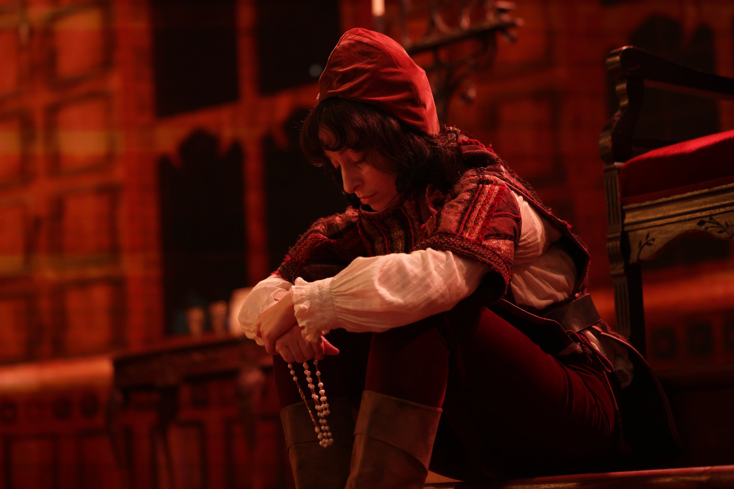  Leslie as Clarence, wearing red shirt and hat and black wig, in  Plump Jack . Photo by Kathrine Kohl. 
