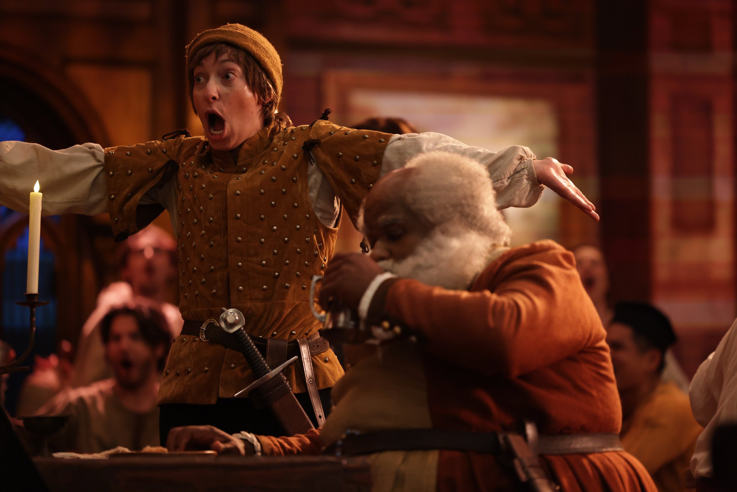  Leslie as Boy, wearing brown shirt and hat and short wig, in  Plump Jack , pictured with castmates. Photo by Kathrine Kohl. 