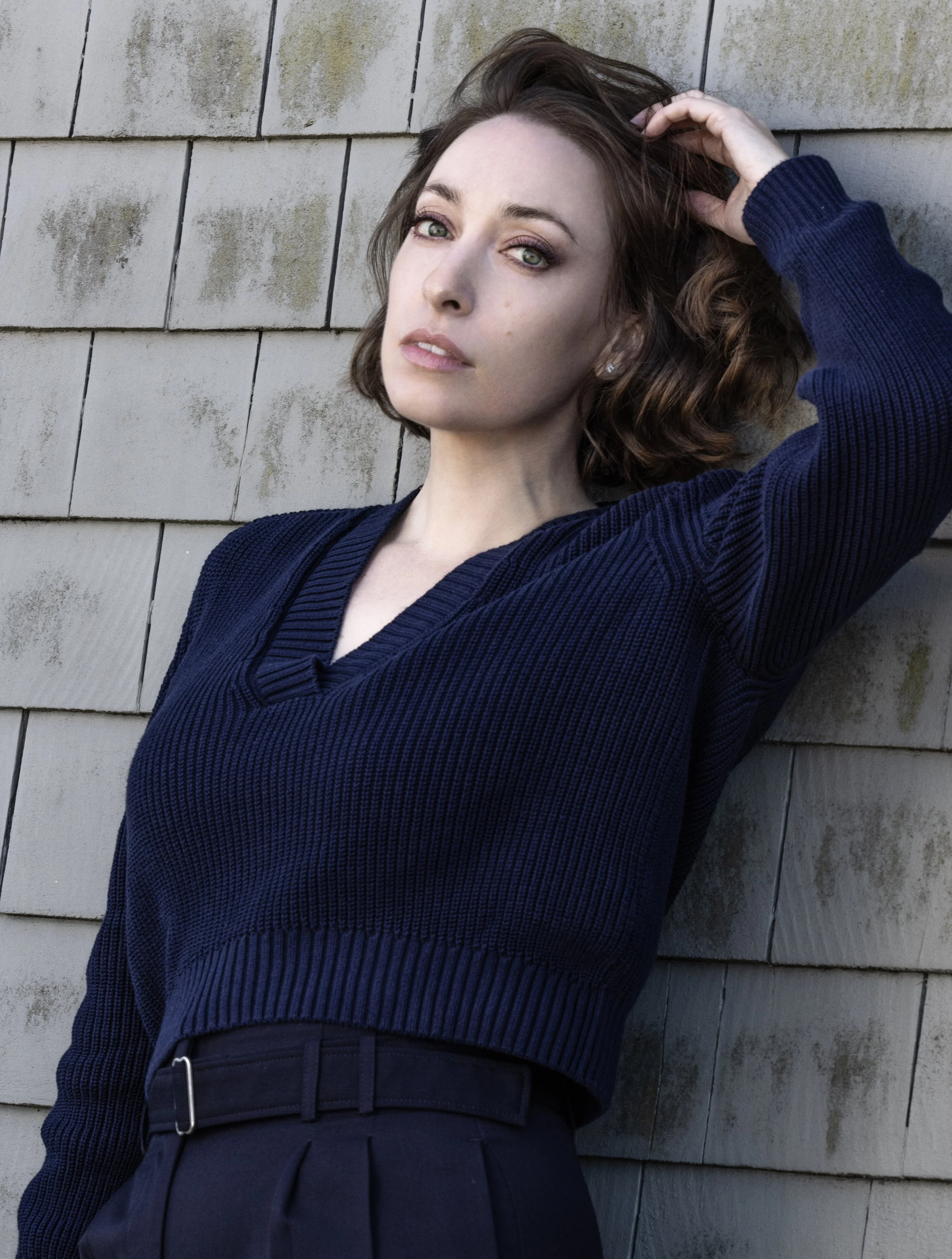  Portrait by Gian Andrea di Stefano featuring Leslie wearing navy blue sweater and dress. 