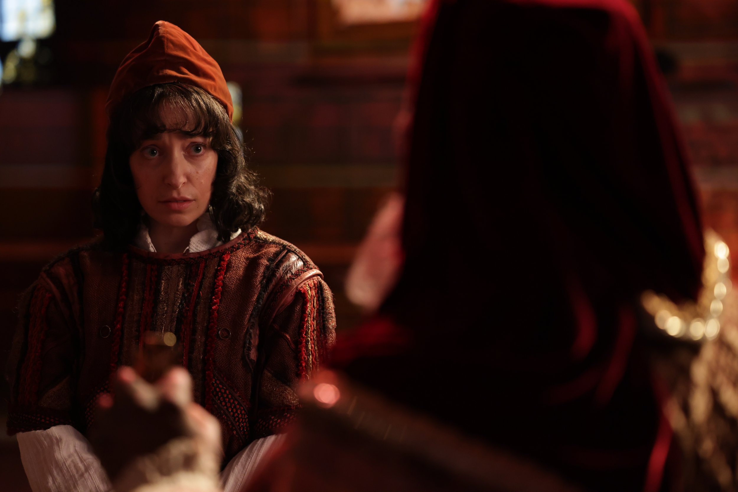 Leslie as Clarence, wearing red shirt and hat and black wig, in Plump Jack. Photo by Kathrine Kohl.