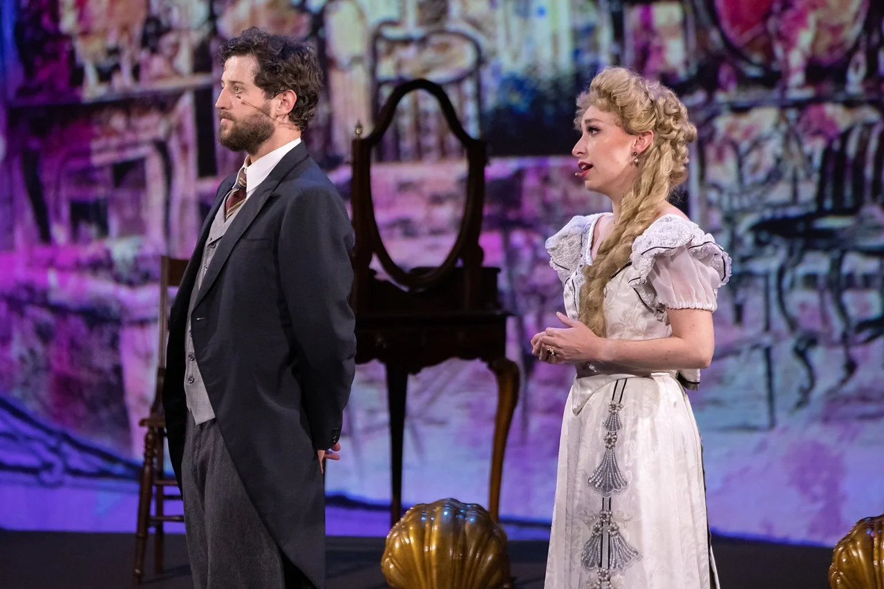  Leslie as Sibella Hallward ,  wearing white wedding dress and blond wig, in  A Gentleman’s Guide to Love and Murder  with Lamplighters Music Theatre, pictured with castmate. Photo by Joe Giammarco. 