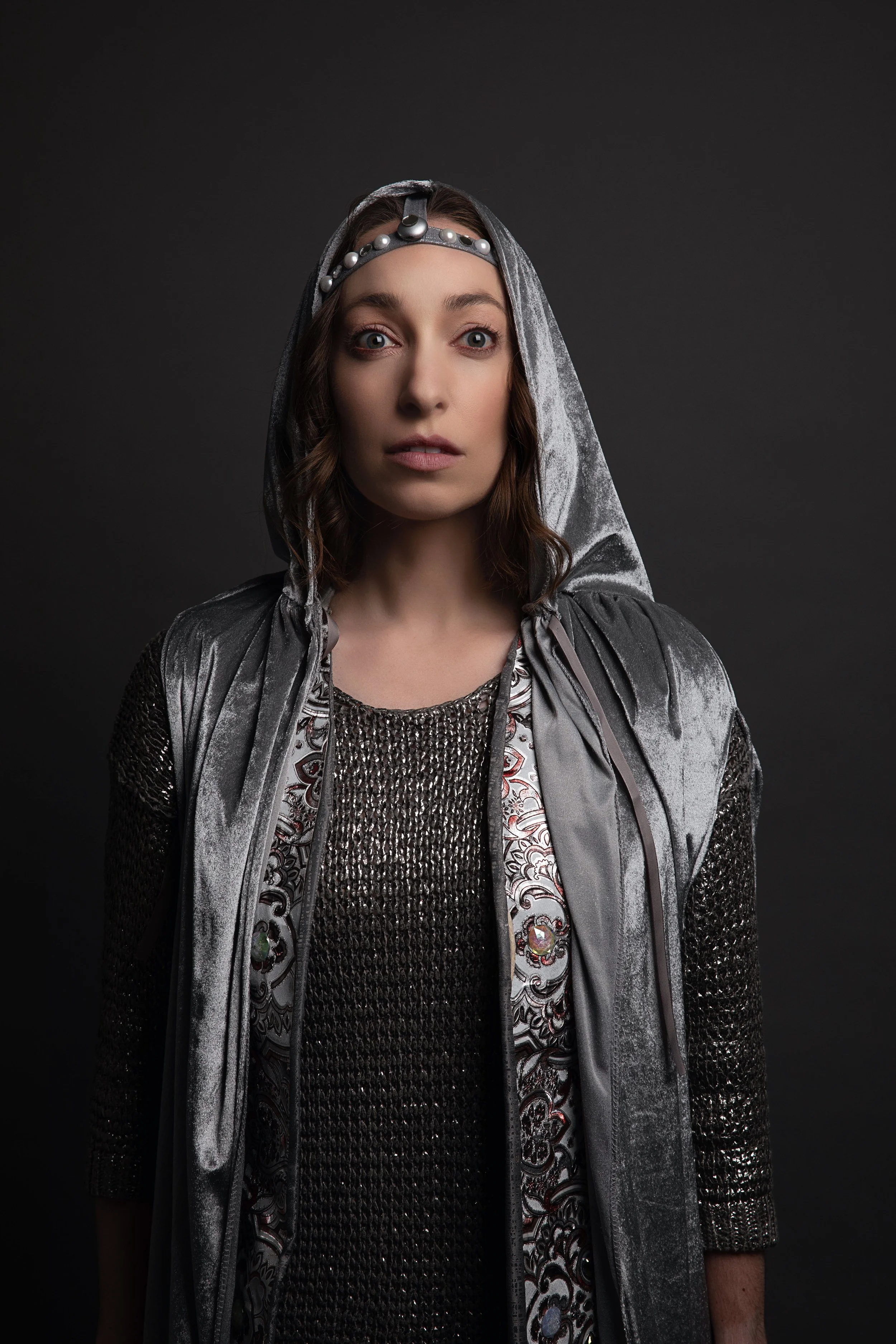  Publicity photo for  Olimpia Vendicata  by Valentina Sadiul featuring Leslie wearing silver hooded cape. 