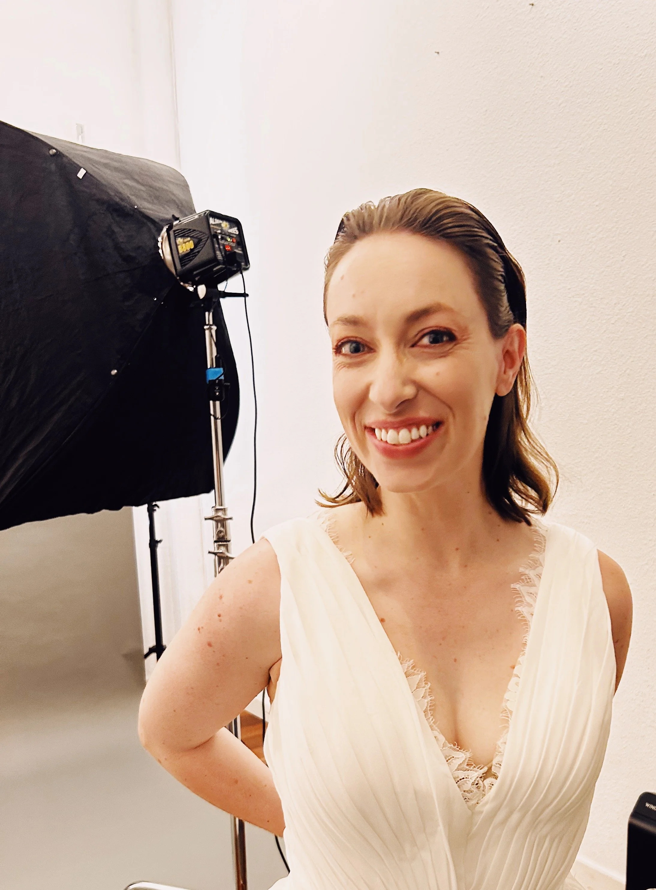 Leslie wearing white dress at photo studio, backstage of publicity shoot for  Olimpia Vendicata.  