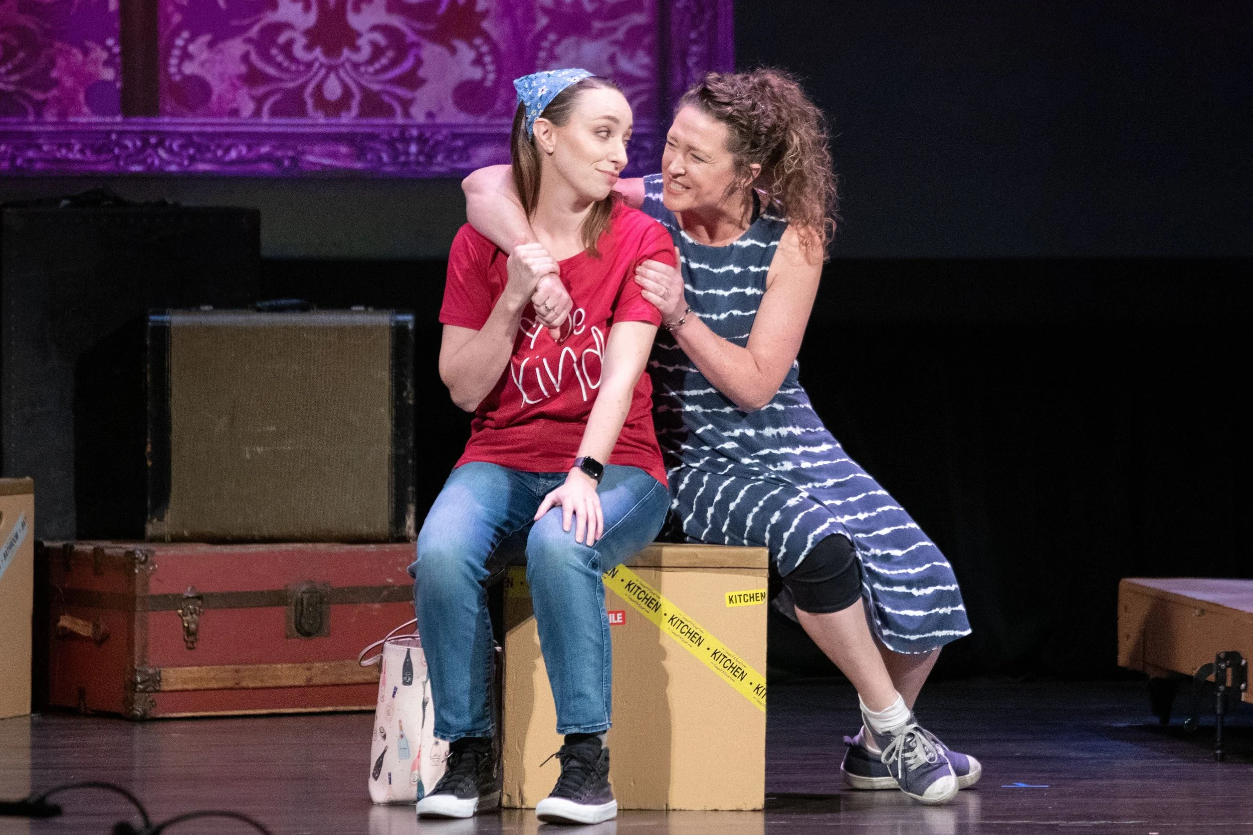  Leslie as Carrie, wearing red tee shirt, jeans, and blue handkerchief, in  Choirstarter  with Lamplighters Music Theatre, pictured with castmate. Photo by Joe Giammarco. 