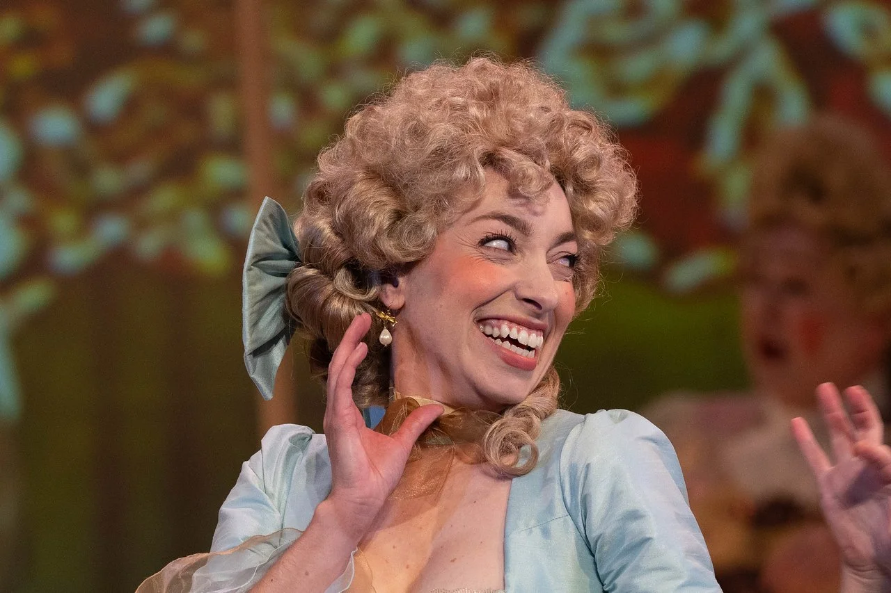  Leslie as Lady Lilette Sauvoirfaire, wearing a blue dress and blond wig, in  By Georges!  with Lamplighters Music Theatre. Photo by Joe Giammarco. 
