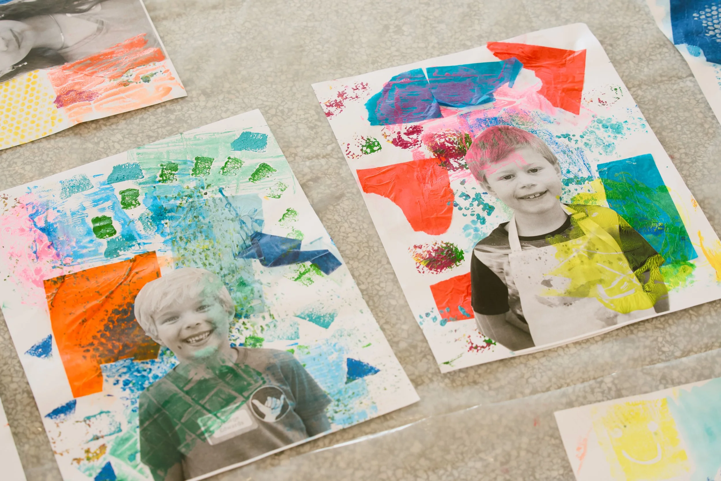 Children's artwork with painted images and a black and white photograph of a smiling boy.