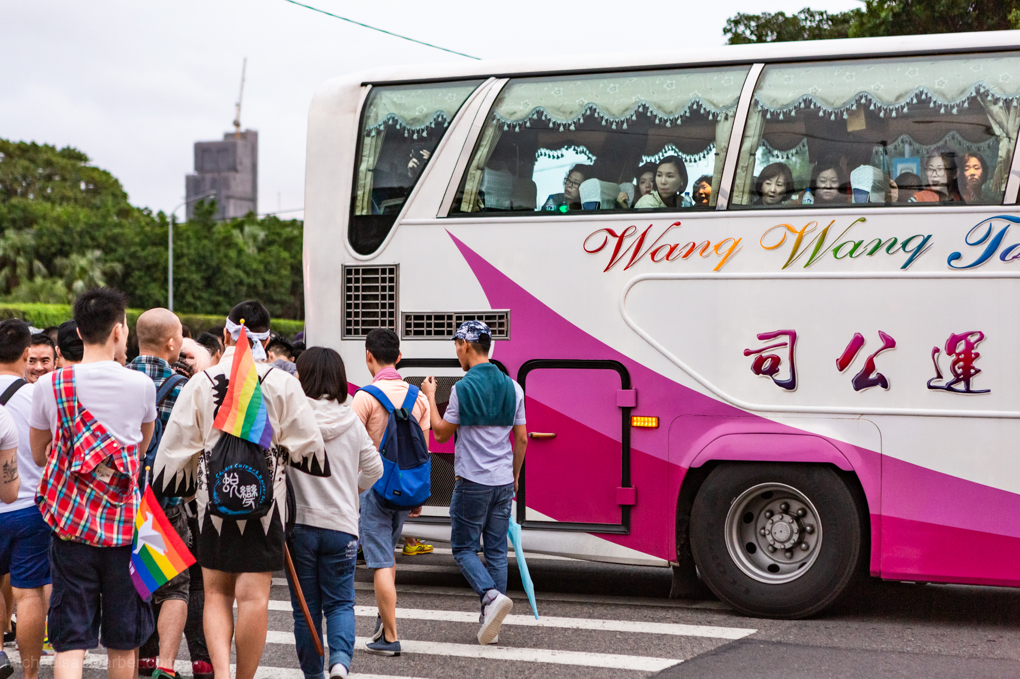 A tour group from The People's Republic of China gawks in amazement at a crowd of tens of thousands of LGBT marchers, Taiwan Pride,2015
