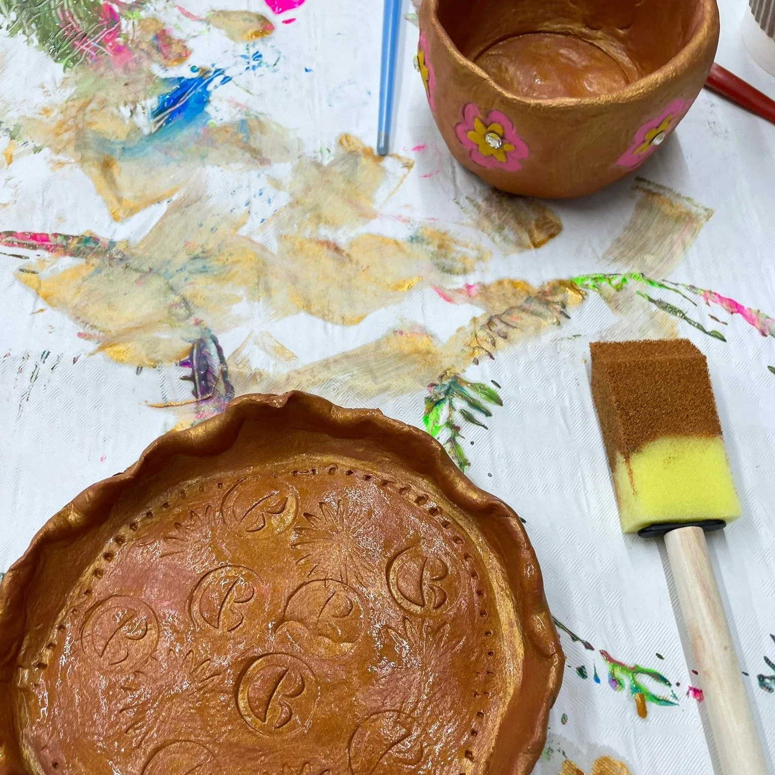 Over two weeks we had the chance to run some clay tile art sessions with Lauren Martin, and it was great to see how quickly some of the women took to working with clay. Each person created something completely their own, shaping their tiles and then 
