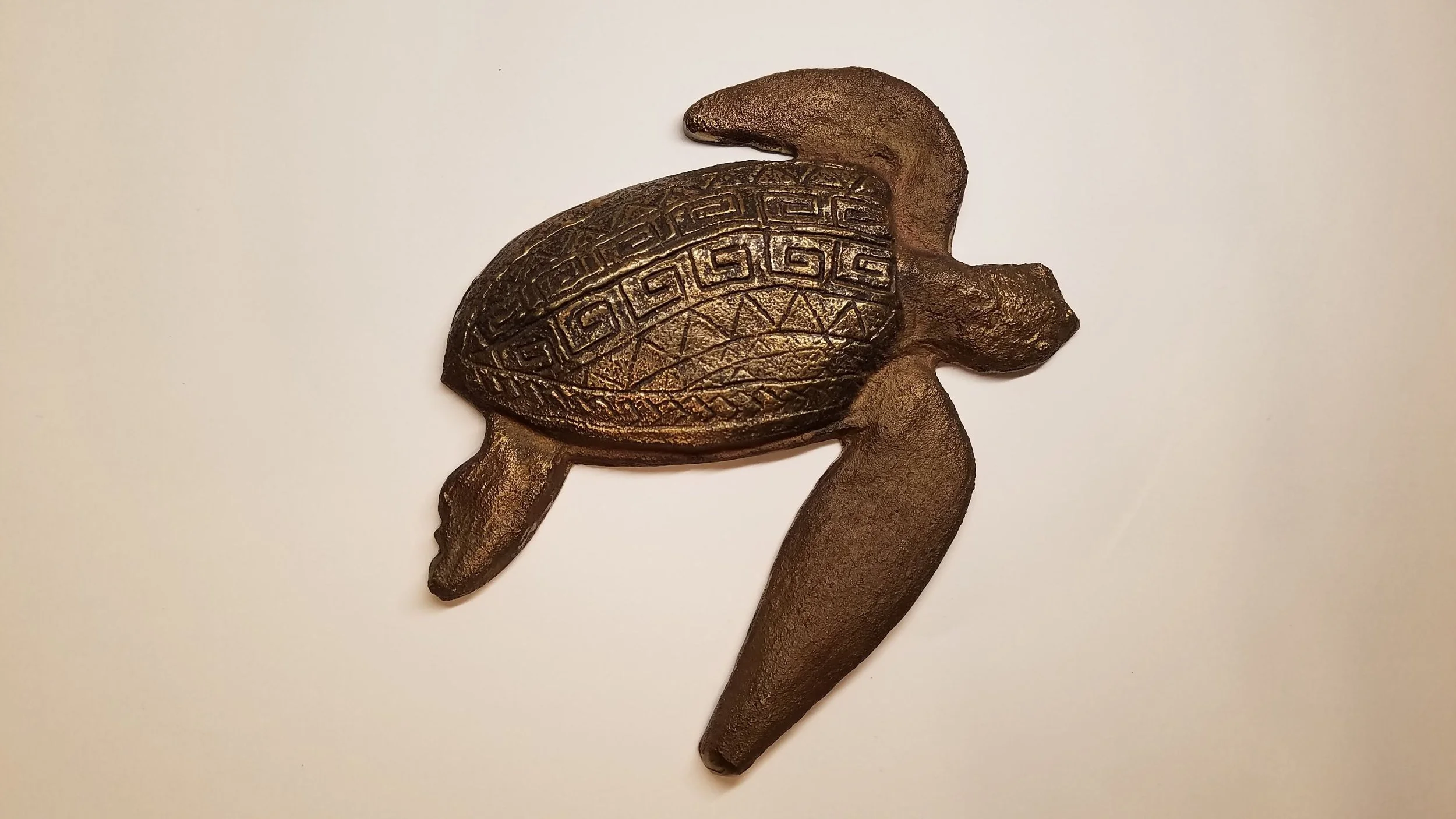  Iterations on bronze baas relief turtles. 