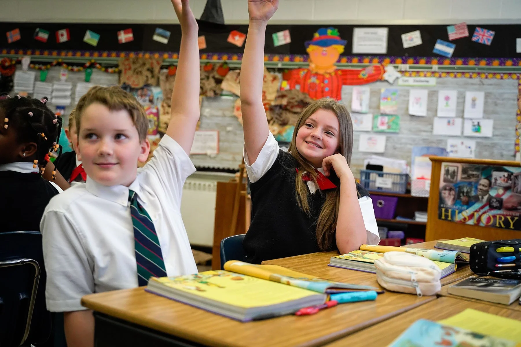 smiling-students-raising-hand-in-class.jpg