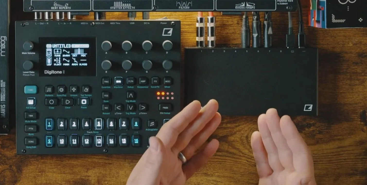 Elektron Outbox 8 connected beside Digitone II, with its numbered output connections and cables visible.