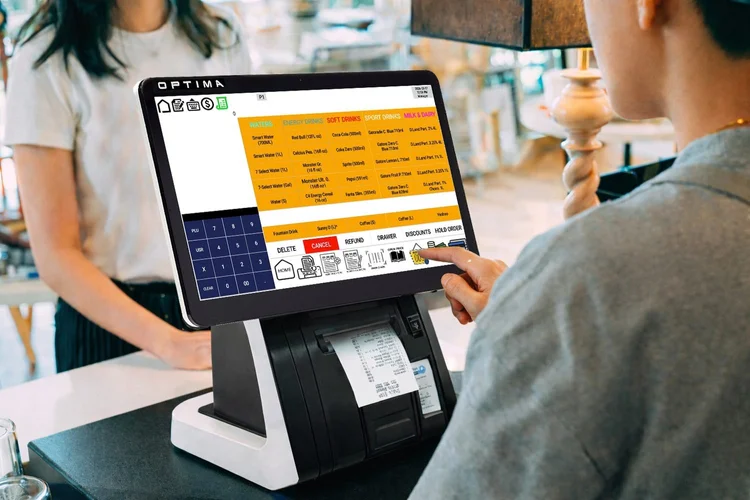 Customer paying at a convenience store counter using an Optima POS terminal