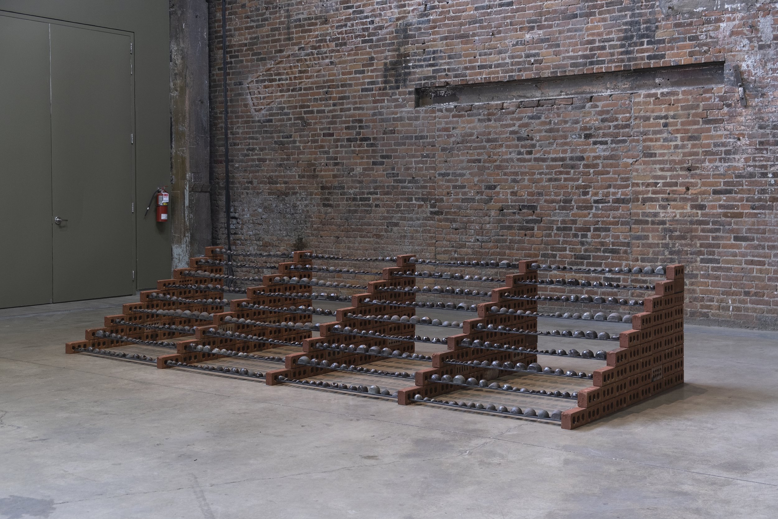   Sameer Farooq   Ascension (Onions) , 2022 Sculptural installation (ceramics, metal rods, bricks) 