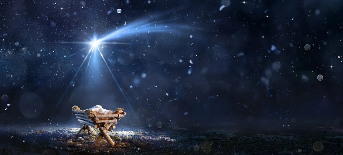 Birth Of Jesus Christ With Manger In Snowy Night And Starry Sky shinning down on the cradle.