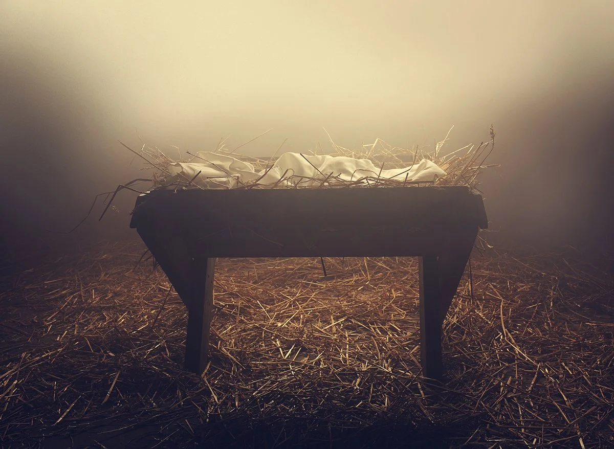 Manger illuminated at night under fog