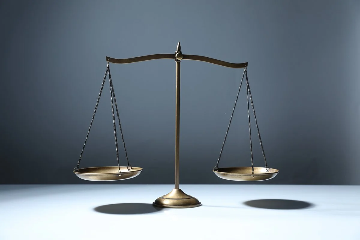 A balanced scale on grey background