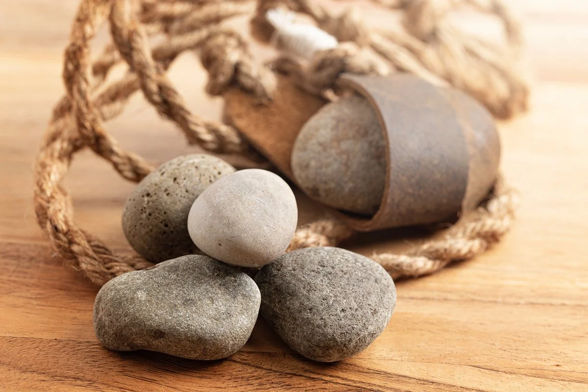 A Sling Shot and Stones on a Wooden Table
