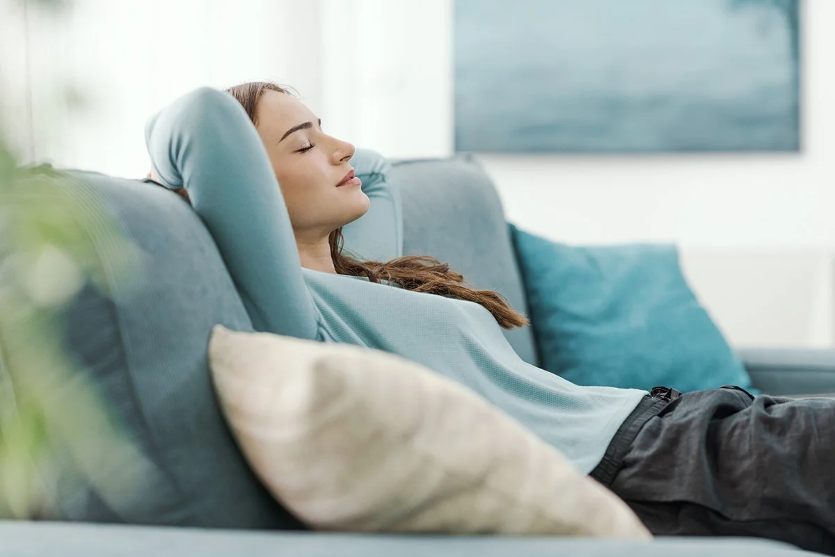 Relaxed young woman napping on the couch