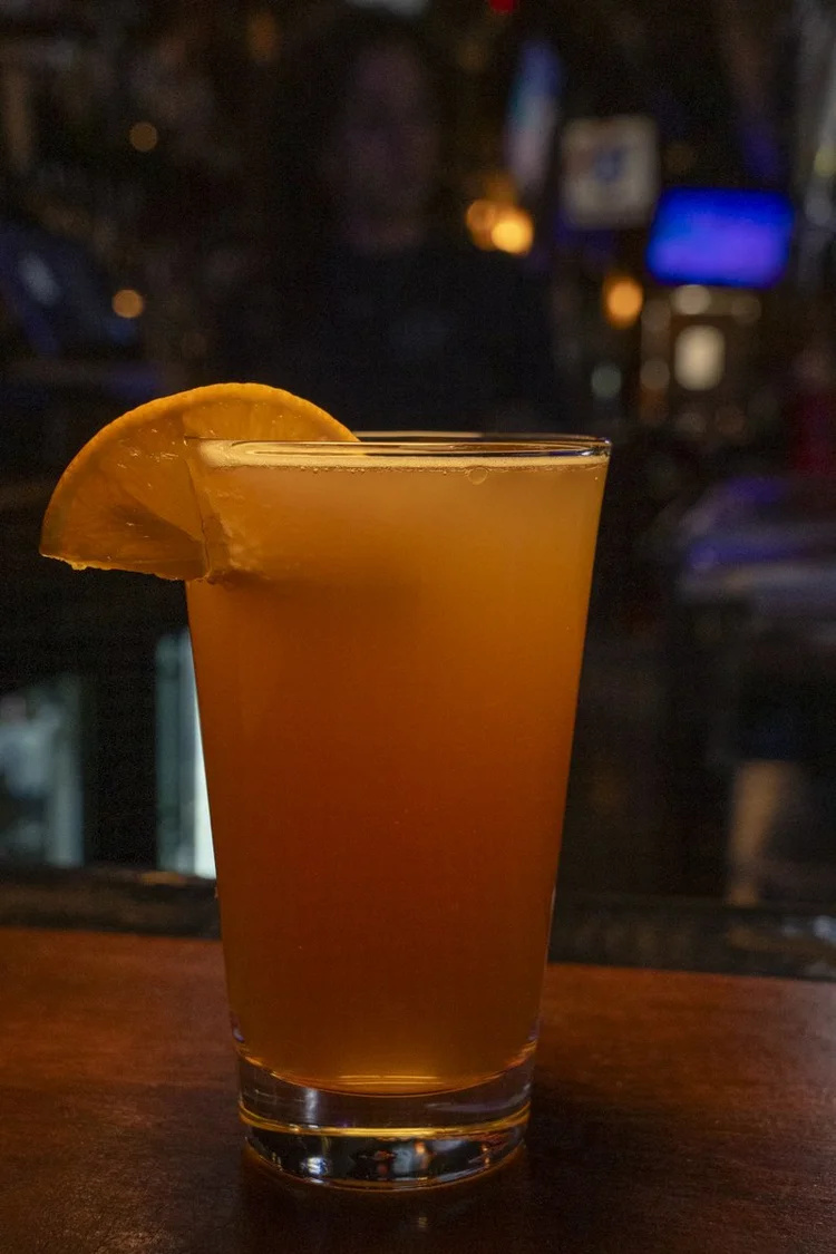 City Tap cocktail with an orange garnish