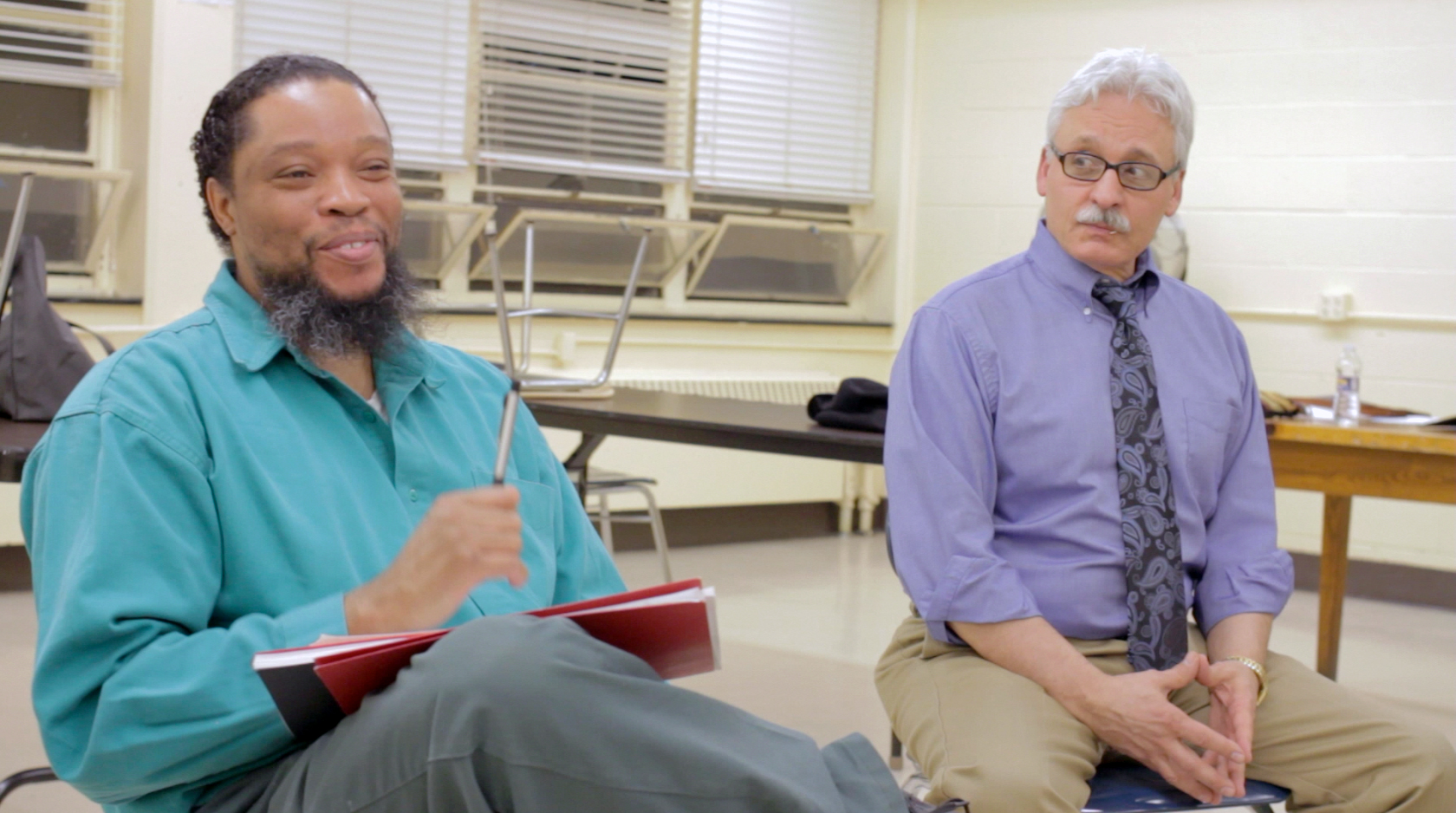 PPTG member, Kenneth Brown, discusses PPTG’s upcoming performance while Auburn Director of Volunteer Services, David Roth, looks on.