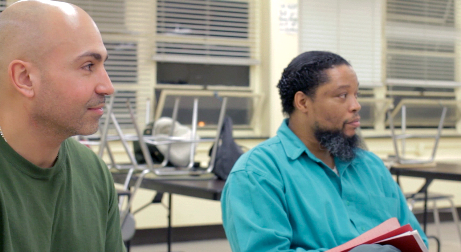 Efraim Diaz and Kenneth Brown listen to a discussion of a piece for performance.