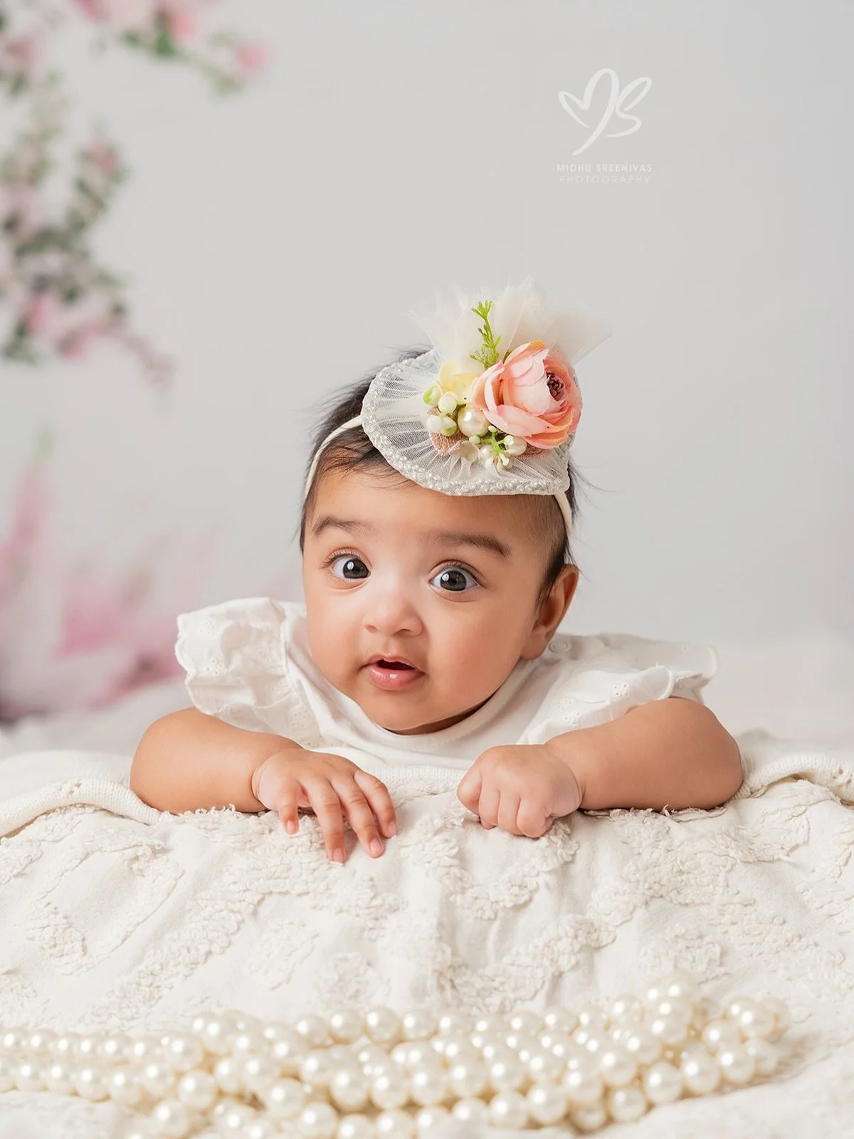 From sleeping like a dream to wide-eyed wonder &mdash; this little princess gave us everything during her 4-month milestone session. 🌸👑 Pearls, flowers, boho vibes &mdash; she wore it all like it was made just for her. Because honestly? It was. 🤍✨