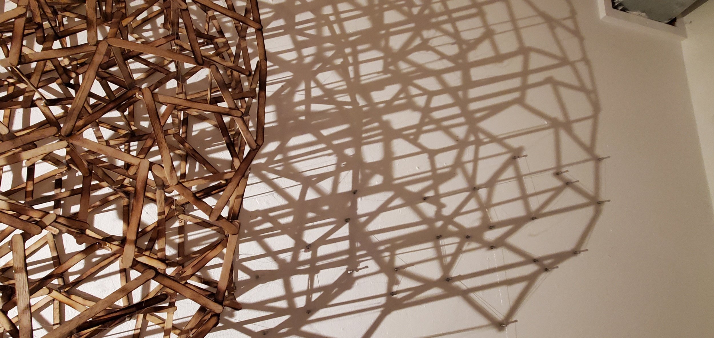 mapping her heartbeat, popsicle sticks, hot glue, shadow, thread, push pins, 32"x40"x10"d (detail)