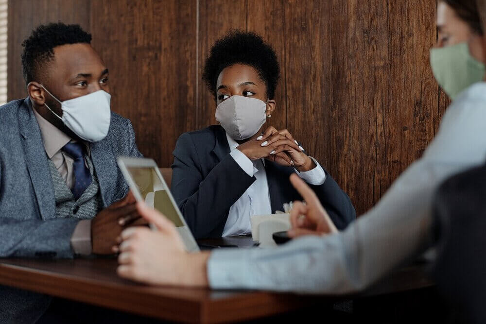 Canva+-+Business+People+Wearing+Face+Masks+and+Talking.jpg