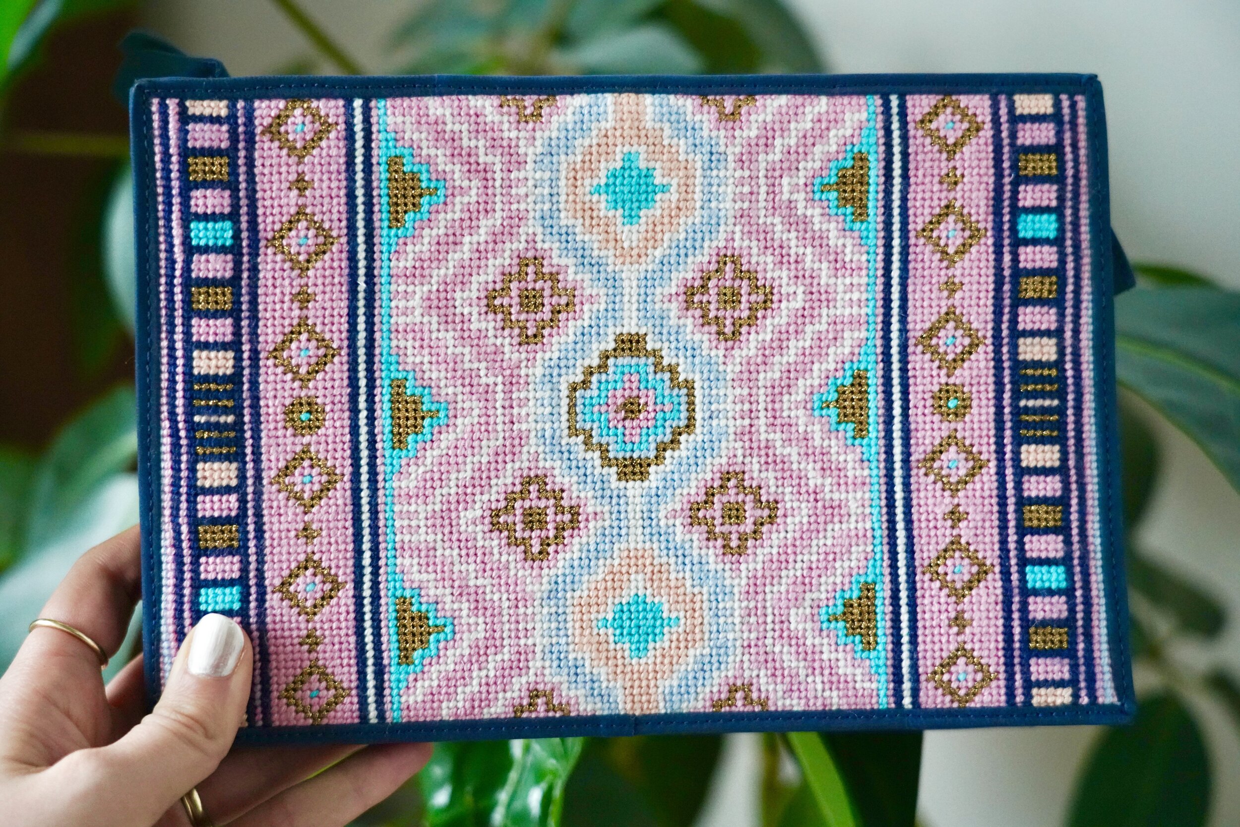 The Cleopatra clutch finished by Needlepoint.Com. I love love love the midnight blue leather they selected for this piece. It certainly hits the mark for what I had envisioned.