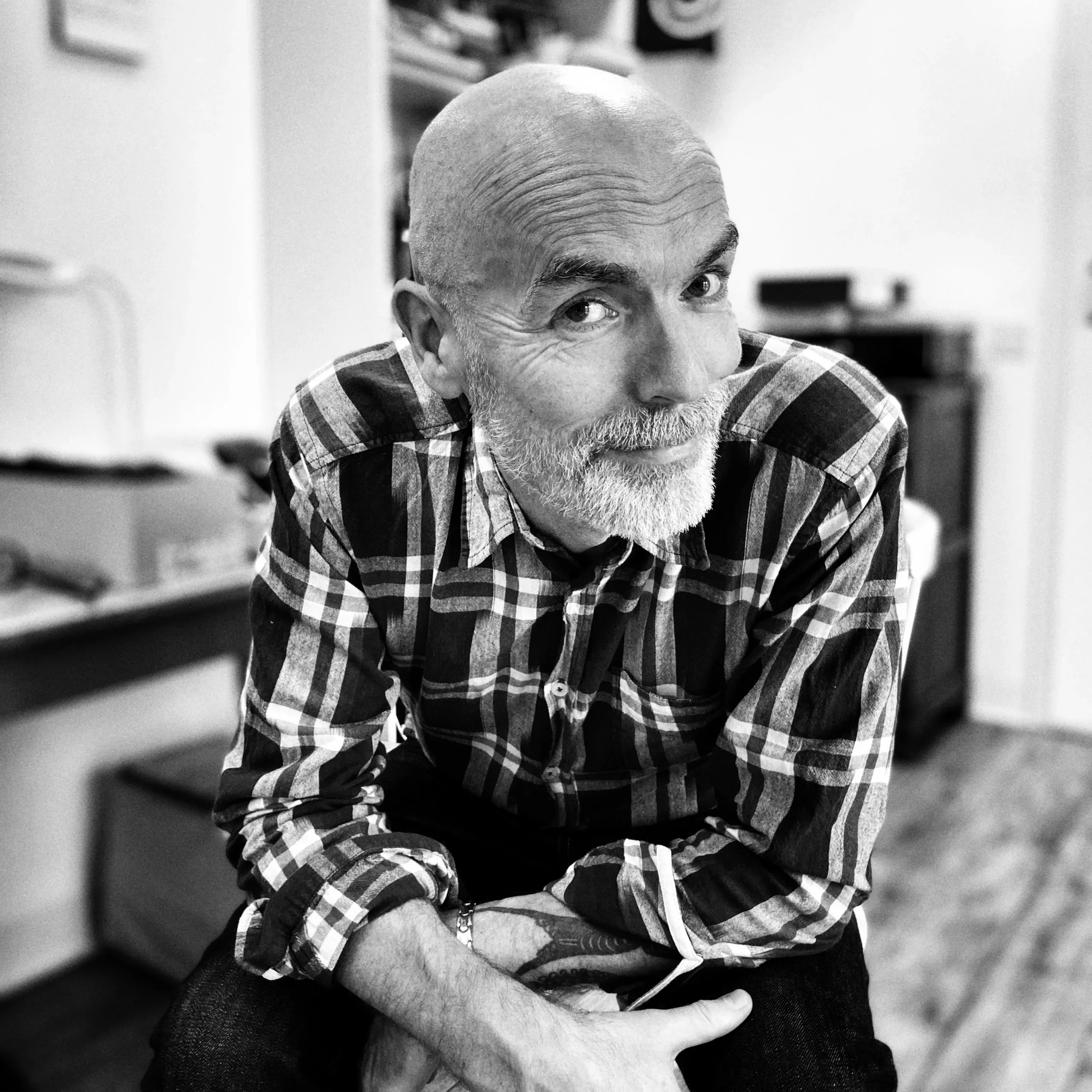A photograph of  fiction writer Sef Hughes at home.