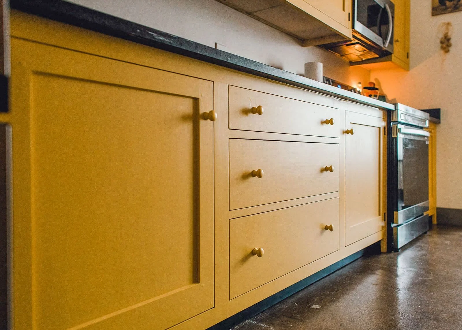Handcrafted cabinet detail showing raised panel door construction with solid hardwood frame and custom hardware