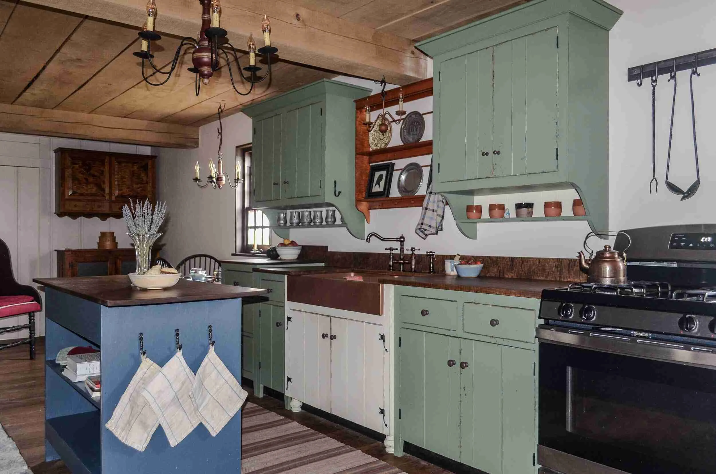 Primitive kitchen cabinetry with board-and-batten construction rustic hand-forged iron hardware in Ohio farmhouse