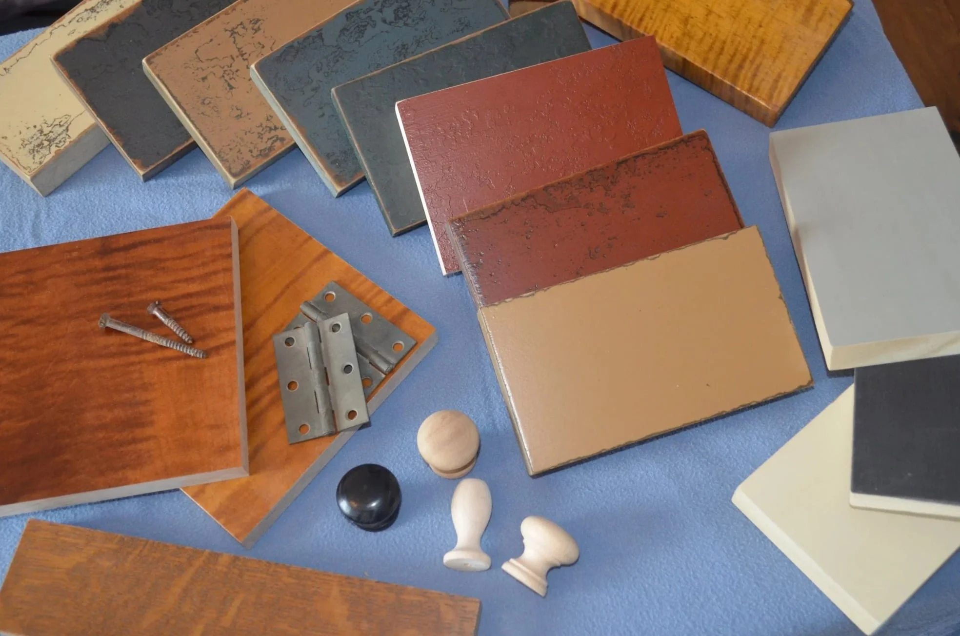 Custom wood finish samples for handcrafted cabinetry including period-accurate stains and milk paint colors