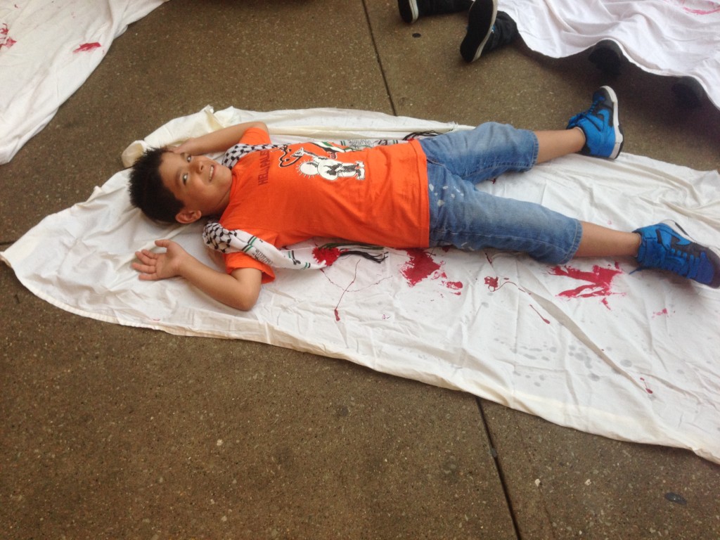 A child who attended the demonstration outside of the Hilton Chicago, 720 s. Michigan Ave., took part in the die-in on Aug. 21.