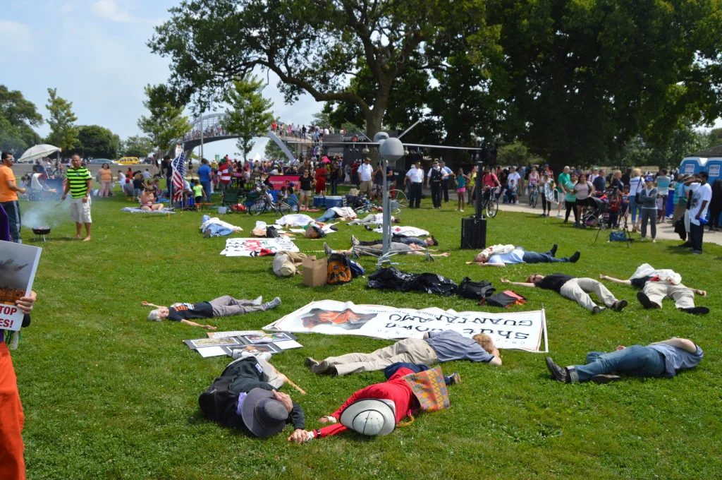 During a demonstration against Boeing, protestors held a die-in at North Ave. beach, where spectators came to watch the Air & Water Show. | Nader Ihmoud