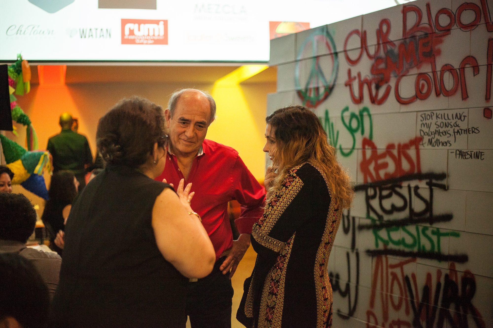 Filmmaker Colette Ghunim (right) speaking with her mother, Iza, and a guest at her fundraising event for "Traces of Home."