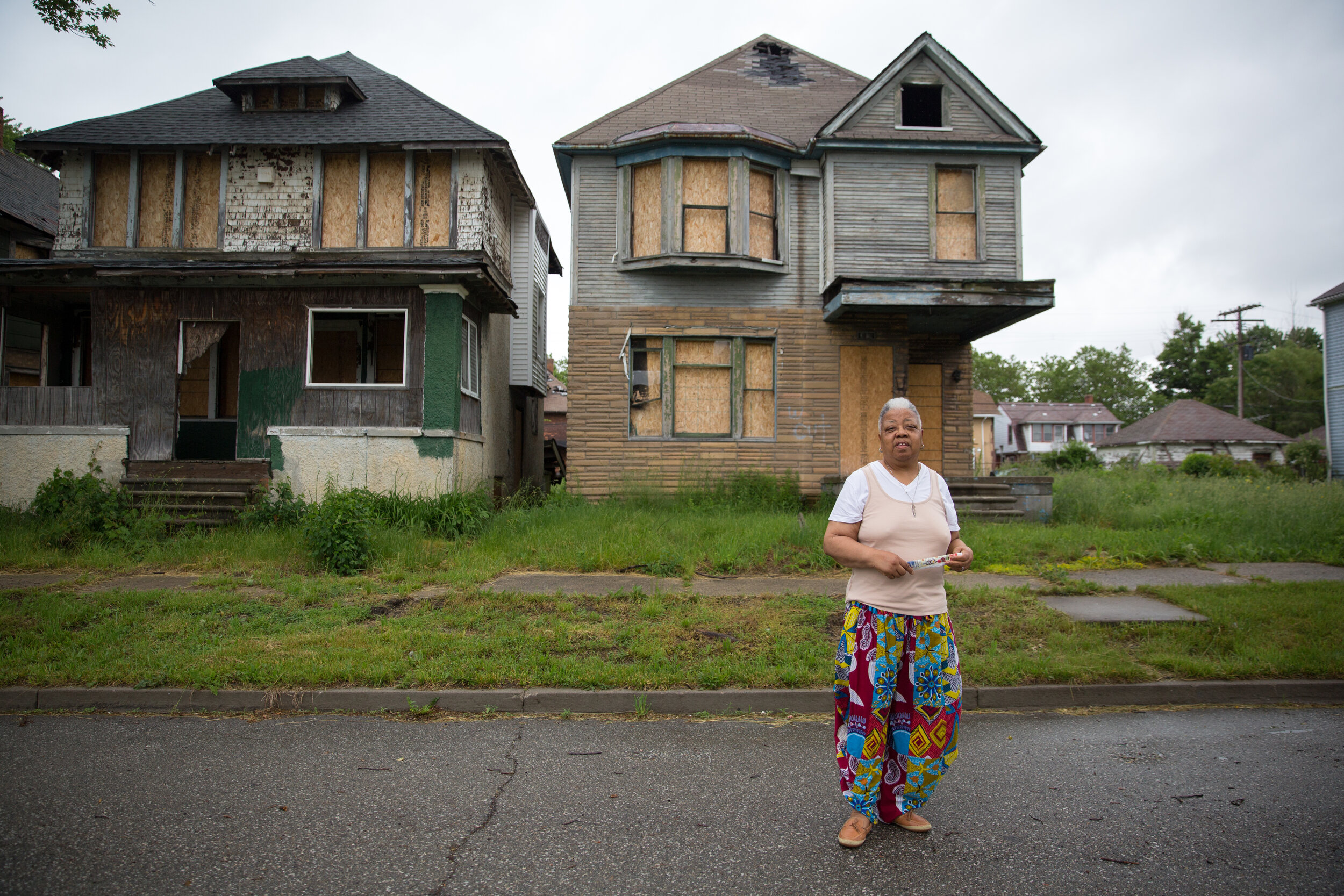  Gloria, a community resident, points to dilapidated homes across the street from her house and talks about her vision for the block in Detroit, Mich., on June 10, 2019. 