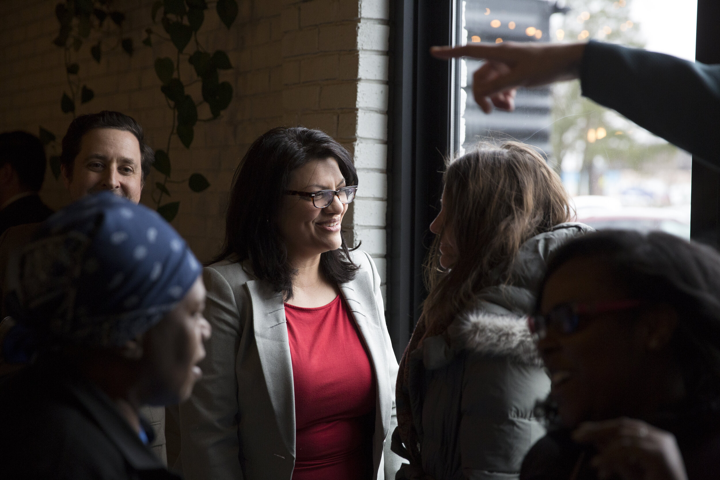  U.S. Rep. Rashida Tlaib talks with supporters at a fundraiser in Detroit, Mich., for her congressional campaign weeks after announcing that she would be running, Monday, March 26, 2018. 