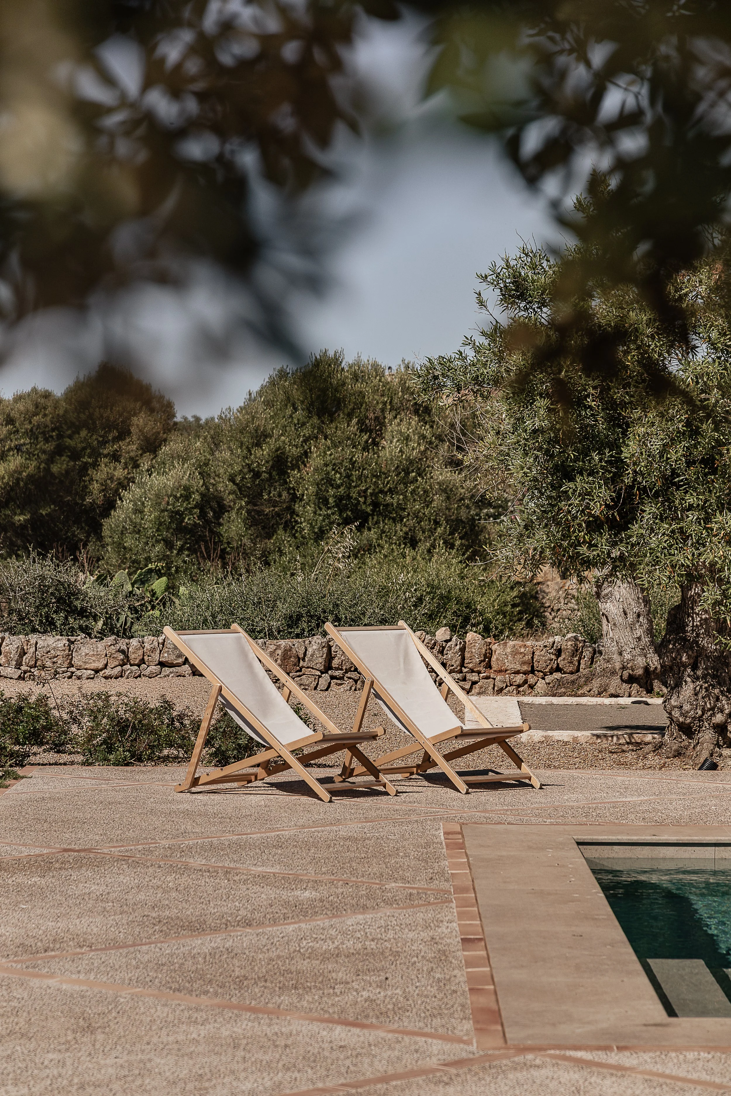 Outdoor terrace with handmade terracotta detailing creating a seamless transition between the interior and exterior of a Mediterranean home in Mallorca.